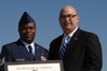 USCIS Director Emilio T. González presents Technical Sergeant Oluwasina Awolusi with the "Outstanding American by Choice" recognition in Baltimore, MD, Sept. 24, 2007