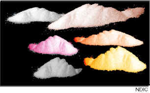 Photograph of several piles of powder in various colors.