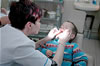 A Dentist examines a child