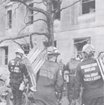 Image of the FEMA Search and Rescue Team walking towards a building.