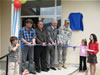 USAID Assistant Administrator Menarchik (3rd from left) joins members of the Vica community and Brig. General Douglas Earhart (far right), in cutting the ribbon to open a new primary school in Vica.