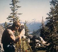 Surveyor with instrument in the mountains.
