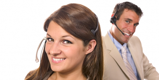 Image of workers wearing telephone headsets