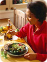 A woman eating a healthy salad.