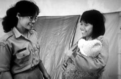 Photo of a health worker with a woman and her child in Indonesia