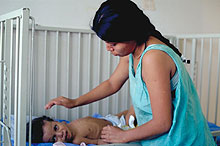 Photo of a mother with child in crib. Source: Davenport