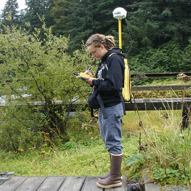 RAINIER Crew member using a backpack GPS unit to obtainpositional information on a pier.