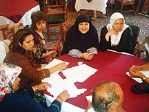 Photo of several women at a meeting.