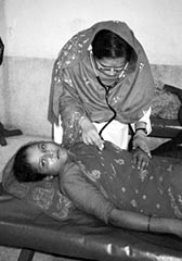 Photo of a physician examining a woman at a Bangladeshi hospital.