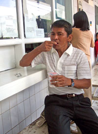 Photo of Mr. Pudjo Prastomo taking his TB medication at an urban PPTI clinic in Central Jakarta, Indonesia. With sputum positive TB, he is on DOTS treatment since December 2002. Source: Ger Steenbergen