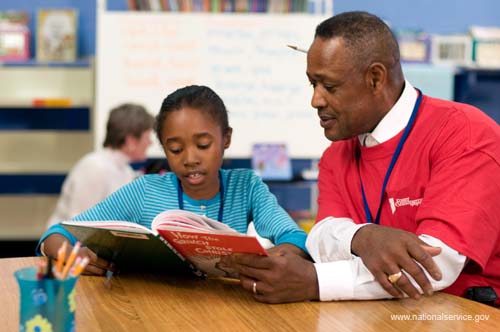 On April 3, 2008, Foster Grandparent Enoch Nelson works with a student on reading comprehension at St. Paul Primary School in Summerton, South Carolina.