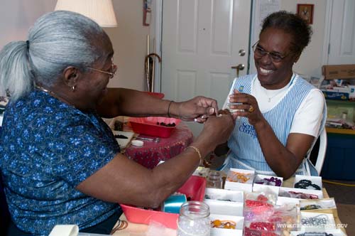 On April 1, 2008, Senior Companion Euphina Irvin spends time with client Costella Black in her home in North Charleston, South Carolina.