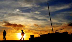 People walk along the quayside at sunset in Paphos, Cyprus, March 25, 2007. [© AP Images]