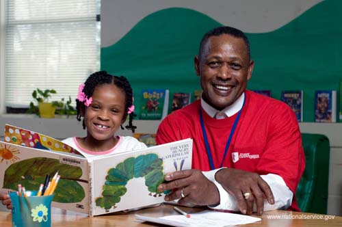 On April 3, 2008, Foster Grandparent Enoch Nelson works with a student on reading comprehension at St. Paul Primary School in Summerton, South Carolina.
