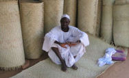 Sudanese man selling carpets