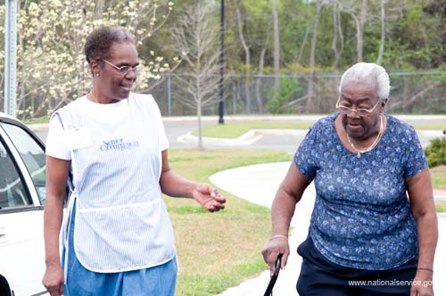 On April 1, 2008, Senior Companion Euphina Irvin takes a walk with client Costella Black outside her home in North Charleston, South Carolina.