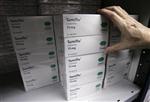 A warehouse manager takes a carton of Tamiflu, which contains the antiviral drug oseltamivir, for packing at a pharmaceuticals storage facility in Singapore March 21, 2007. REUTERS/Nicky Loh