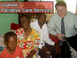 Photo of Dr. Hill chatting with a Ugandan family receiving palliative care services from Hospice Africa Uganda (click here to learn more).