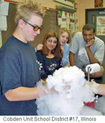 Picture of a student holding a beaker with dry ice (frozen carbon dioxide).