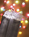 A gift with colored lights in the background; linking to the Holiday Safety Consumer Focus.