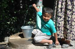 An Uzbek boy fills up on fresh water
from the Kyrgyz well.