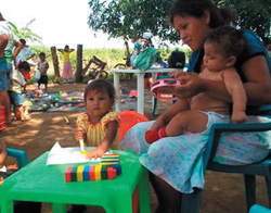 Photo: Families meet at a Rural Community Children’s Center to monitor their child’s development and receive complementary food.