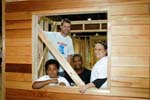 Volunteers proudly display their handiwork -- a playhouse that will donated to a recreation center or homeless shelter in the Philadelphia area. The playhouse was built as one of several service projects during the National Conference on Volunteering and National Service. Project partners included YouthBuild Philadelphia Charter School and YouthBuild USA. AmeriCorps members serving with the YouthBuild Philadelphia Charter School helped manage the build.