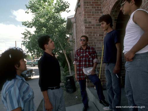 VISTA members Teresa Cordero and Rosendo Montes (plaid shirt) demonstrate conflict resolution techniques to teenagers at the Salazar Housing Project in El Paso, Texas, in 1986.