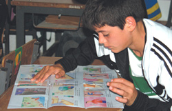 Photo of boy reading antitrafficking brochure.