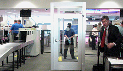 TSA monitors passenger activity at a checkpoint at Sacramento  International Airport.