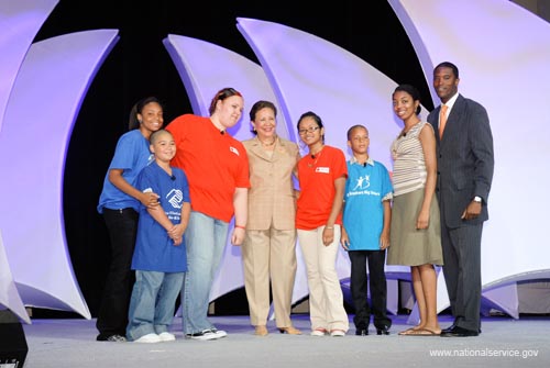 Philadelphia children, who described themselves as "the promise of America," greeted Alma Powell, chair of the America's Promise Alliance, before Mrs. Powell's keynote address to the National Conference on Volunteering and Service. From the left are Tiana Posey, Edward Matos, Christiana Santiago, Mrs. Powell, Sandy Mean, Lenny Pena, Misha Hill, and Jahi Davis. Davis was an AmeriCorps member serving with YouthBuild USA at the time of the Presidents' Summit on the Future of America in Philadelphia in 1997.