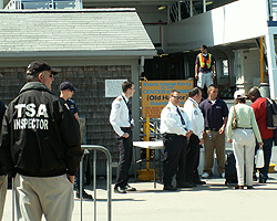 Officers from T. F. Green Airport (Providence, R.I.) observe passengers boarding the Point Judith to Block Island Ferry as a Coast Guard petty officer and two TSA surface transportation security inspectors look on. Photo by Bob Thorne.