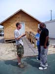 Pass Christian, MS - AmeriCorps St. Louis/Emergency Response Team leader Josh Smith counsels a couple in Pass Christian, Miss. about how to seek building permits and other assistance.