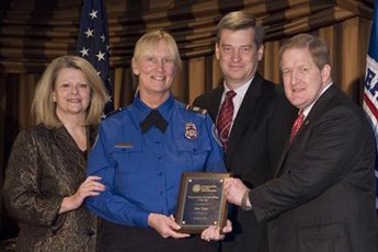 Holding her award is TSO Mary Trapp (second from left), General Mitchell International Airport (Milwaukee, Wis.), who was recognized with two fellow officers as Transportation Security Officers of the Year. Joining Trapp is (from left), Deputy Administrator Gale Rossides, Security Operations Assistant Administrator Lee Kair, and Administrator Kip Hawley. Photo by Avalon Blenman.