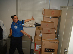 Photo of TSO Kim Herrera showing the boxes packed with this year's uniform donations.