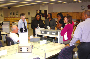 Photo of (from left) an unidentified NARA researcher; Maxie Phillips, tour guide, NARA; Florita Bynum, records liaison, TSA; Lawan Jackson, records management officer, TSA; Tiffany McKnight, Lauren Dang and Dusty Schlee, records liaisons, TSA; and Ivan King, archives specialist, NARA