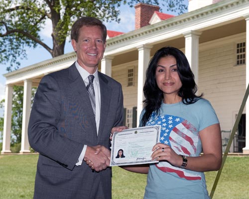 Director Scharfen congratulating a new citizen