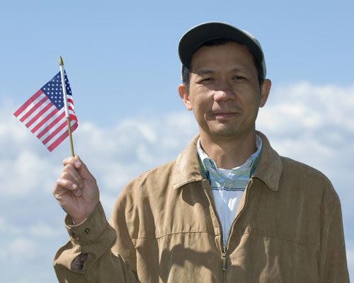 A new citizen of the United States of America, waving Old Glory