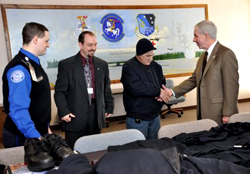 A Vietnam veteran who received a donated uniform greets 

group at the Veterans Medical Center.