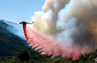 A helitanker drops fire retardant along mountain slopes in Santa Barbara, Cailif. Friday as the 4-day-old blaze spread to 3,500 acres. 