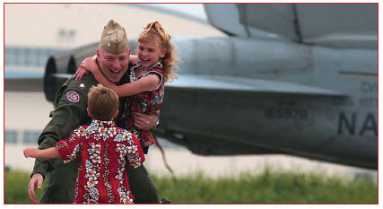 soldier hugs his children