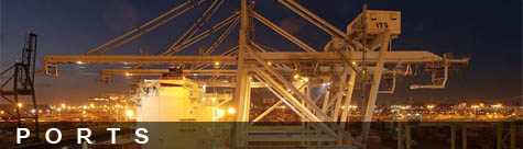 Photo of ship at dock and container cranes