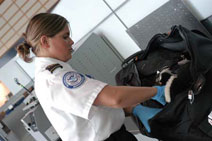 Photo officer screening a bag