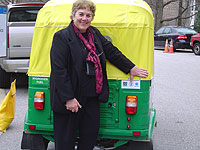 Photo of Cindy Lowry (USAID) admiring the Bajaj auto rickshaw, converted to run on 100 percent hydrogen, displayed at the 16th Annual US Hydrogen Conference, 'Partnering for the Global Hydrogen Future.'