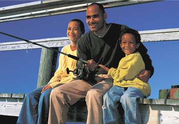 An African-American father and sons fishing.