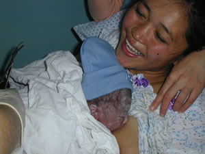 Image of a woman nursing her newborn immediately after birth. The safe motherhood approach promotes immediate skin-to-skin contact with a newborn infant
Photo Credit: ZdravPlus IIP