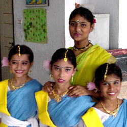 Photo: Four young South Asian women in traditional dress.