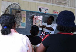 Photo: A healthcare professional giving a presentation at a prevention of mother to child transmission group education session. 