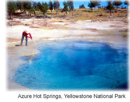 Picture of a scientist taking a water sample from a spring. 