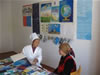 A trained midwife is providing counseling to a Chon-Gara villager